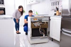 A man fixing a dishwasher
