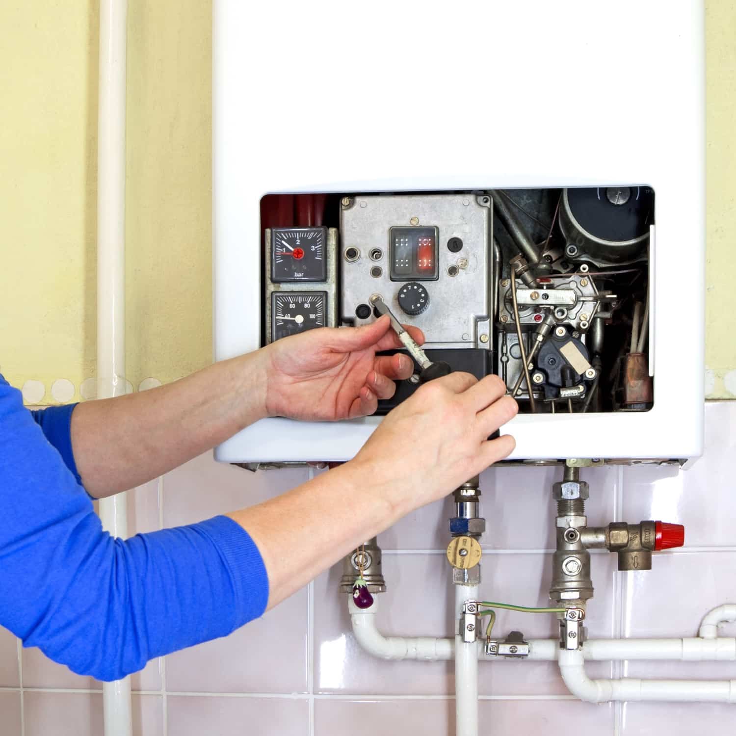 Plumber performing repairs on a tankless water heater