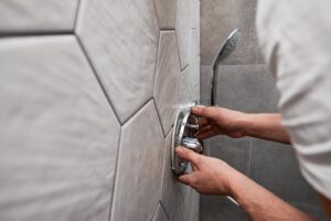 Plumber installing new shower fixtures